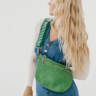 Woman wearing the Pretty Simple Westlyn Bum Bag in emerald green with a green striped adjustable strap, styled crossbody over a denim dress
