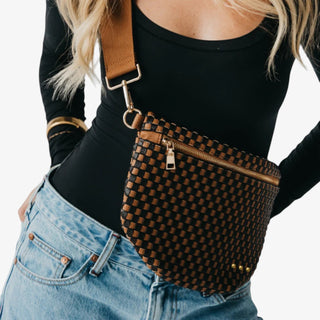 Woman wearing a Pretty Simple Westlyn Woven Bum Bag in checkered coffee and black with gold zipper, styled with a black top and pinstripe blazer.