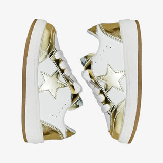 White sneakers with gold stars and soles on a white background