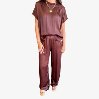Woman wearing a brown outfit on a white background