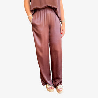 Brown pants worn by a person on a white background