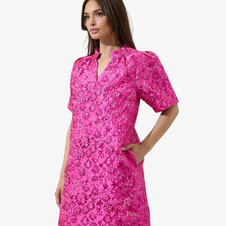 Fuchsia jacquard mini dress with puff sleeves, floral texture, and metallic shimmer for a bold, feminine statement look.