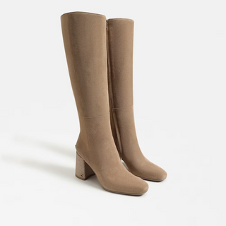 Pair of beige knee-high boots on a white background