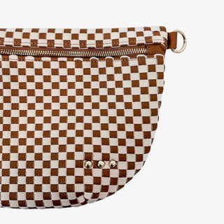 Woman wearing a Pretty Simple Westlyn Woven Bum Bag in checkered brown and cream with gold zipper, styled with white top and denim jeans.