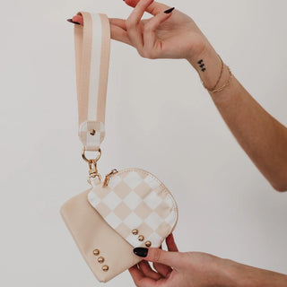 A collection of vibrant colored wristlet pouches with gold stud details, available in multiple colors.