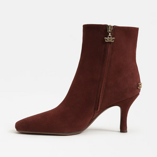 Brown ankle boot with a gold zipper on a white background