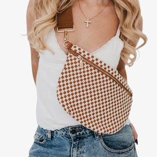 Woman wearing a Pretty Simple Westlyn Woven Bum Bag in checkered brown and cream with gold zipper, styled with white top and denim jeans.