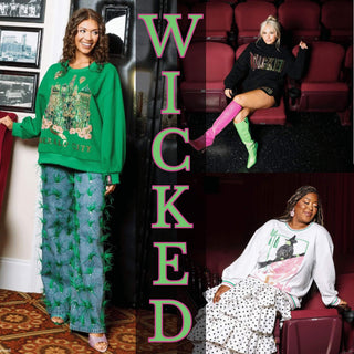 Models wearing Queen of Sparkles Wicked sweatshirts inspired by the musical, featuring Emerald City, Glinda, and Elphaba designs.