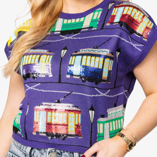 Mardi Gras apparel, jewelry, and accessories in purple, green, and gold for parade and Krewe season