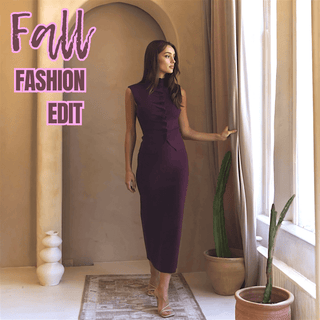 Woman in a sleeveless merlot midi dress standing by a window, styled for the Fall Fashion Edit collection at Hoity Toity Boutique.