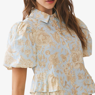 Blue floral peplum top with puff sleeves and collared button front detail styled with neutral high waisted pants