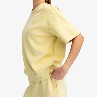 Striped Scuba Top in Butter Yellow with white stripes, short sleeves and matching shorts, model side view