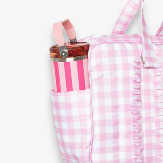 Pink and white checkered bag with a water bottle in a pocket on a white background