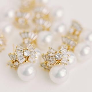 gold pearl bow drop earrings with crystal detail elegant front view