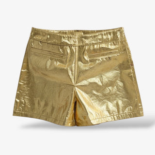 Metallic gold high-waisted shorts with a sleek structured fit, featuring back welt pockets and a bold shine for a chic statement look.