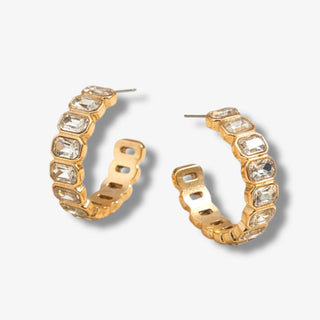 Gold rhinestone hoop earrings with emerald cut clear crystal stones in a structured statement hoop design