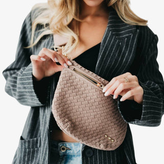 Taupe suede woven Westlyn Bum Bag with adjustable strap and gold hardware displayed on a white background.