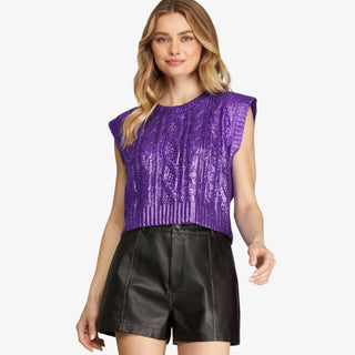 Purple metallic cropped cable knit sweater with structured shoulders and high-shine finish.