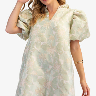Sage floral puff sleeve mini dress with V-neckline and A-line fit on model wearing white flats