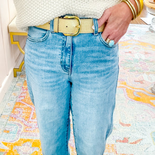 Woman wearing Gold Metallic Leather Belt with denim jeans and cream sweater.