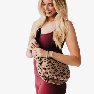 Leopard sherpa crossbody bag with a soft texture, adjustable strap, and roomy interior—an easy, on-trend bag for everyday fall and winter outfits.