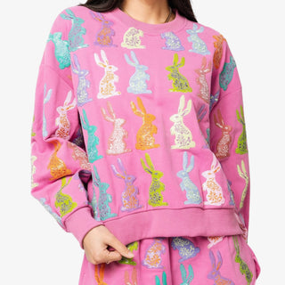 Pink sweatshirt with colorful rabbit sequin pattern worn by a person