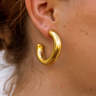 Jolie chunky gold hoop earrings with a smooth shiny finish