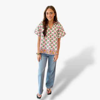 Pink petal print split neck top with short sleeves paired with light wash jeans full outfit view