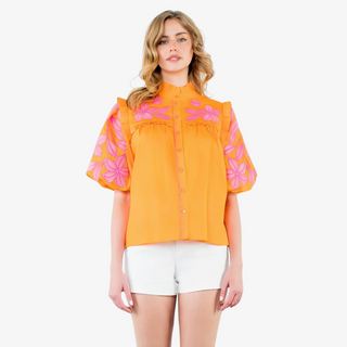 Close-up of puff sleeve detail on the Flora Embroidered Top with pink floral embroidery