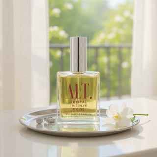 Perfume bottle labeled 'A.L.T. Crystal Intense No.32' on a table with a blurred outdoor background