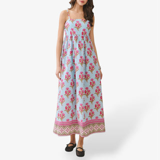 Blue floral maxi dress with pink botanical print, square neckline, adjustable spaghetti straps, flowy tiered skirt, and decorative border hem.