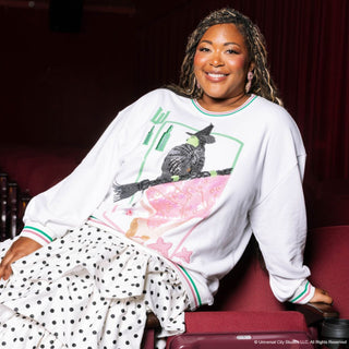 Model wearing Licensed Elphaba & Glinda Card Sweatshirt with sequin Wicked character design