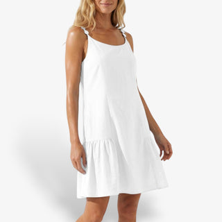White cotton ruffle mini dress with sleeveless design and flowy hem styled outfit