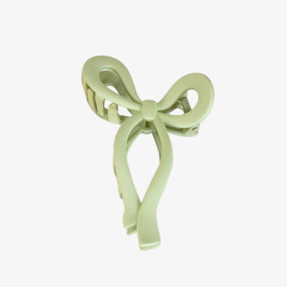 Light green bow-shaped hair clip on a white background