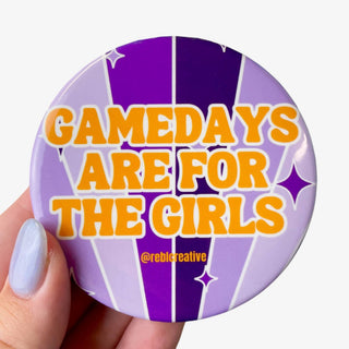 3-inch Game Days Are for the Girls button with bold gold lettering on a retro purple striped background, front view