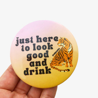 3-inch Just Here to Look Good and Drink game day button with a seated tiger on a pink and gold background, front view
