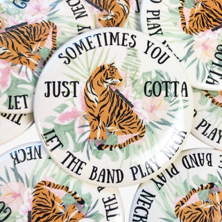 3-inch Sometimes You Just Gotta Let the Band Play Neck game day button with a tiger and tropical floral design, front view