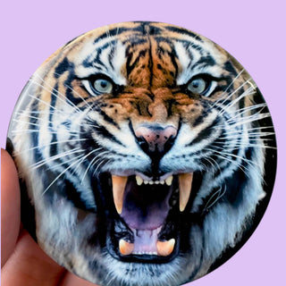 3-inch Mad Tiger Black game day button featuring a close-up of a roaring tiger with blue eyes, front view
