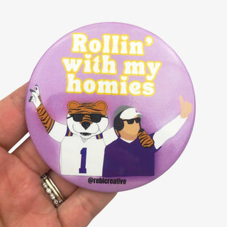 3-inch Rollin’ with My Homies game day button featuring a tiger mascot and coach wearing sunglasses on a purple background, front view