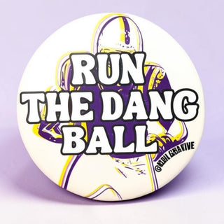 3-inch Run the Dang Ball game day button with purple and gold football player design, front view