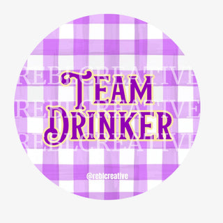 3-inch Team Drinker game day button with purple and gold lettering on a purple plaid background, front view