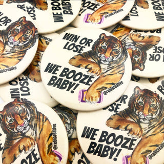 3-inch Win or Lose We Booze Baby game day button featuring a watercolor tiger holding a purple drink on a cream background, front view