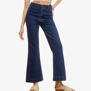 Woman wearing high rise kick flare dark wash denim jeans with cropped wide leg fit