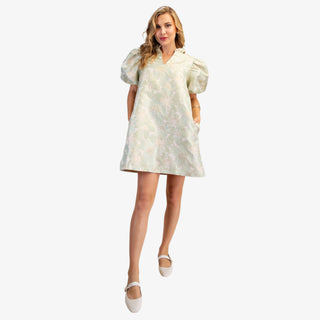 Sage floral puff sleeve mini dress with V-neckline and A-line fit on model wearing white flats