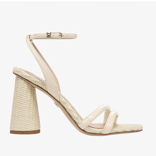 Beige sandal with woven heel on a white background