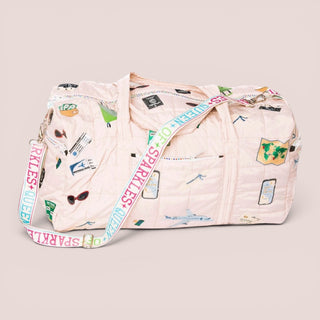 Ivory nude quilted travel duffle bag with sequin and rhinestone travel icons front view with adjustable shoulder strap for weekend travel