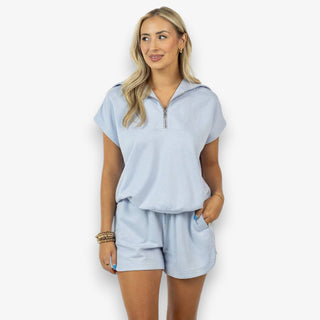 blue lounge set zip neck top and shorts casual outfit front view