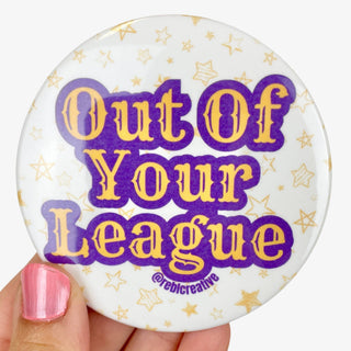 Out of Your League button in purple and gold with star background, LSU game day accessory