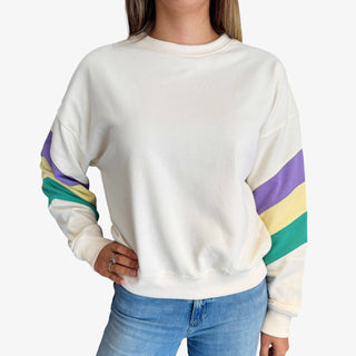 Mardi Gras stripe sweatshirt with purple green and gold sleeve details on a cream crewneck top