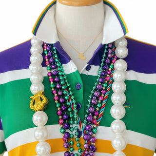 Mannequin wearing a colorful shirt with multiple beads and gold Louisiana pendant on a white background
